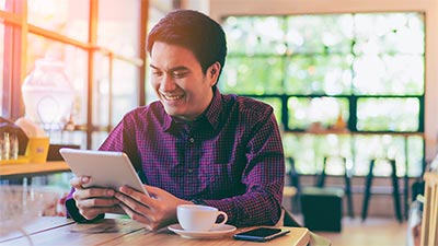 Man using a tablet in a cafe
